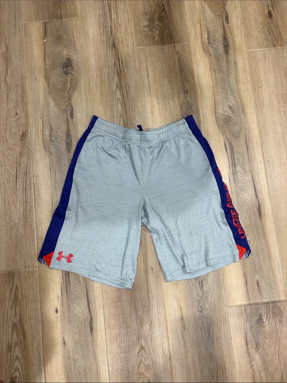 Under Armour Men’s Light Gray Athletic Shorts with Blue Panels and Red Accents